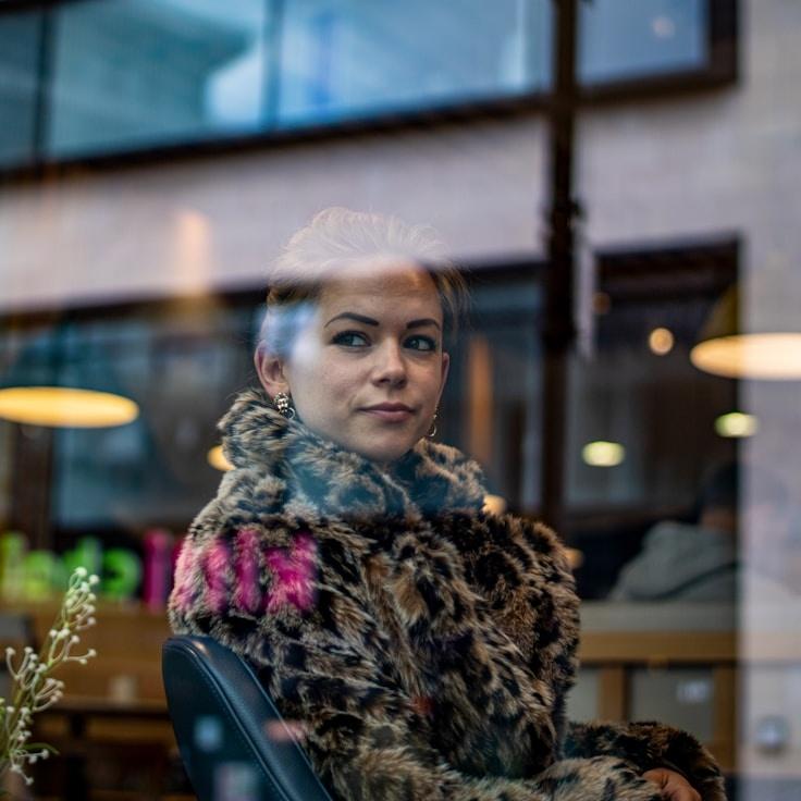 Alex Carter, Lead Design Curator at Whispering Forest Path, reviewing corporate floral arrangements